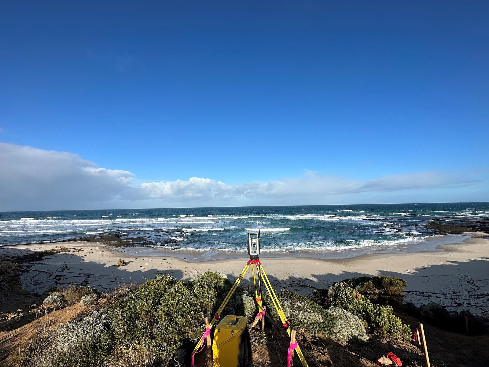 Surveyor operating a total station in the field